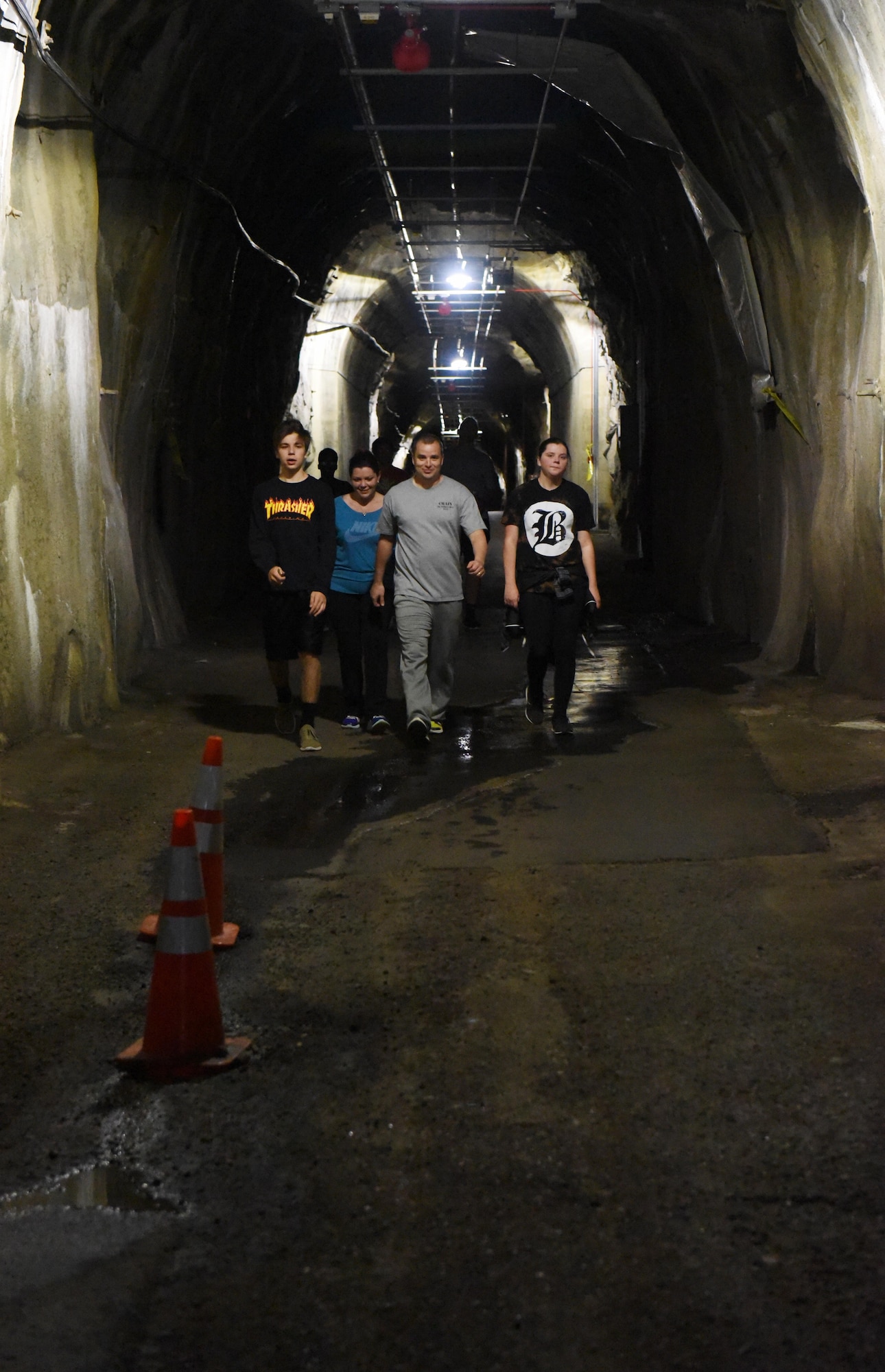 CHEYENNE MOUNTAIN AIR FORCE STATION, Colo. – A group of participants stay close together as they travel down the dark tunnel of Cheyenne Mountain during the Zombie 5K at Cheyenne Mountain Air Force Station, Colo., Nov. 4, 2016. Runners had the chance to take a peek at the blast door entrance into the facility. (U.S. Air Force photo by David Meade)