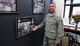 Air Force Reserve 910th Airlift Wing Command Chief Master Sgt. Robert Potts shows off one of the squadron photo collages hanging in the new wing’s Airman’s Suite during grand opening festivities for the space at the installation headquarters building here, November 6, 2016. The new facility highlights the accomplishments of base Units and serves a variety of purposes from meetings to promotion and awards boards. (U.S. Air Force photo/Tech. Sgt. James Brock)