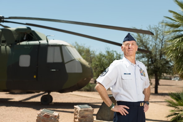 Retired Chief Master Sgt. Craig Bergman stands in front of the HH-3 "Jolly Green Giant" at Davis-Monthan Air Force Base, Ariz., May 19, 2016. Bergman retired as the maintenance superintendent for the 943rd Maintenance Squadron in 2007, having been one of five U.S. Air Force Reserve Airmen to establish the 71st Special Operations Squadron and bring the HH-3 here. His family's military legacy dates back to World War I. (U.S. Air Force photo by Tech. Sgt. Carolyn Herrick)