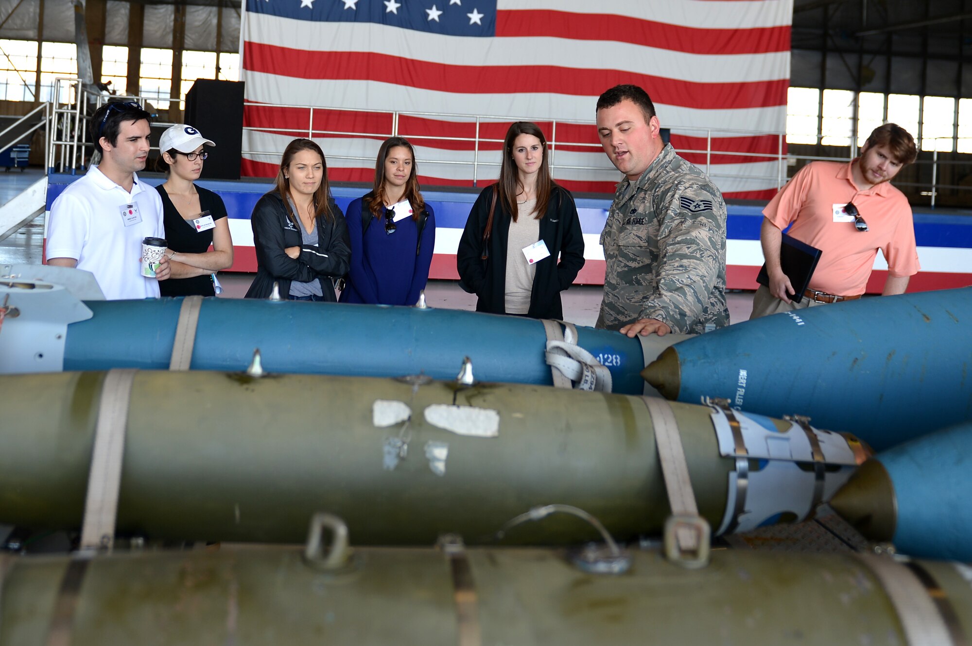 A U.S. Airman assigned to the 20th Fighter Wing briefs congressional staff members on different types of munitions during an East Coast Airpower Demonstration static displays tour at Shaw Air Force Base, S.C., Oct. 28, 2016. During their visit individuals had the opportunity to see the various weapons and munitions utilized by aircraft stationed at military installations along the East Coast. (U.S. Air Force photo by Airman 1st Class Christopher Maldonado)