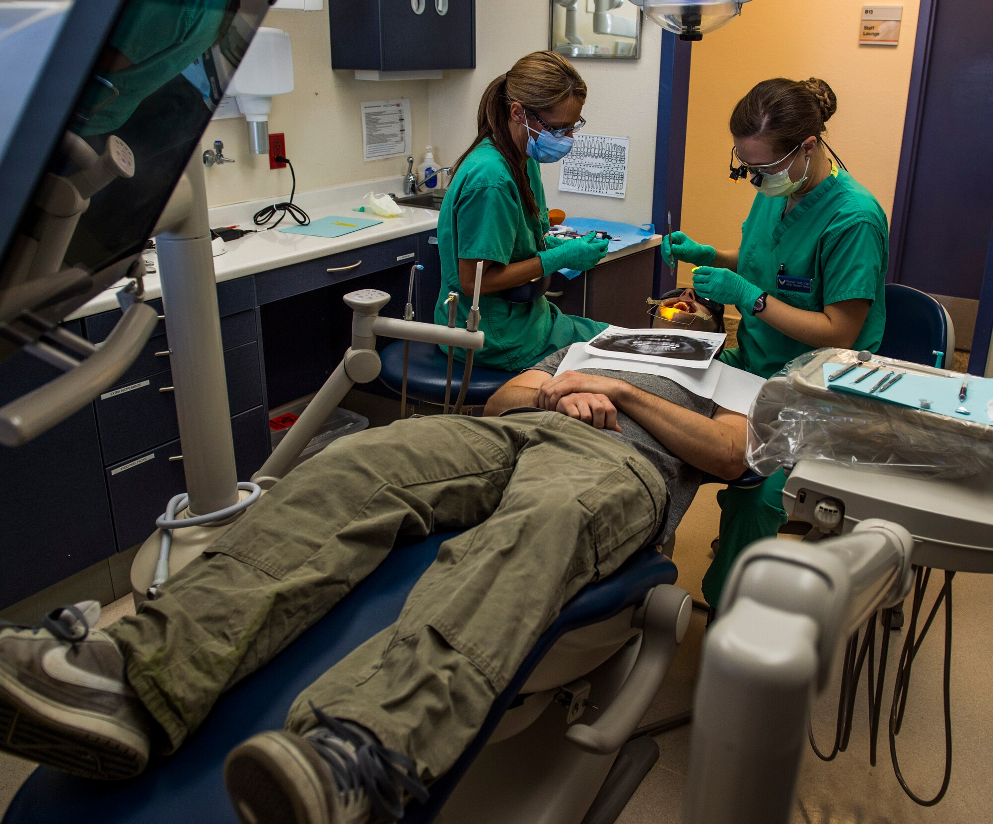 Capt. Rachael Sells and her dental assistant conduct an operation giving a patient braces, Scott Air Force Base, Ill., Oct. 25, 2016. Sells is one of four residents in the Advanced Education in General Dentistry Program.