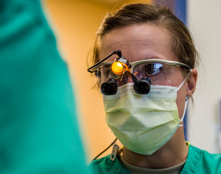 Capt. Rachael Sells coordinates with her dental assistant during an operation to give a patient braces, Scott Air Force Base, Ill., Oct. 25, 2016. Sells is one of four residents in the Advanced Education in General Dentistry Program.