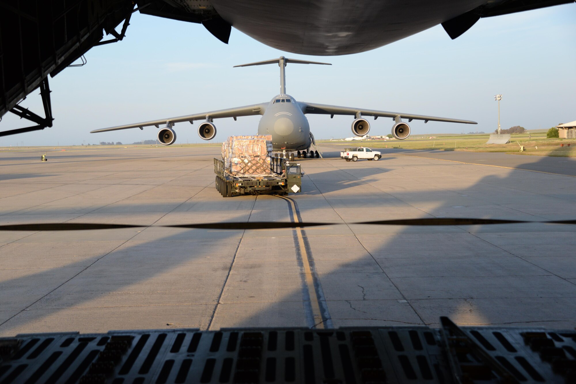 Airmen from the 60th Aerial Port Squadron load a C-5M Super Galaxy with essential cargo and U.S. Army Bridge Erection boats and bridges, May 12, 2016, at Travis Air Force Base, Calif. The bridges and cargo were flown to Iraq by the 22nd Airlift Squadron and directly contributed to the counter-Islamic State of Iraq and the Levant campaign during Operation Inherent Resolve in Mosul, Iraq. (U.S. Air Force photos by Senior Airman Amber Carter)