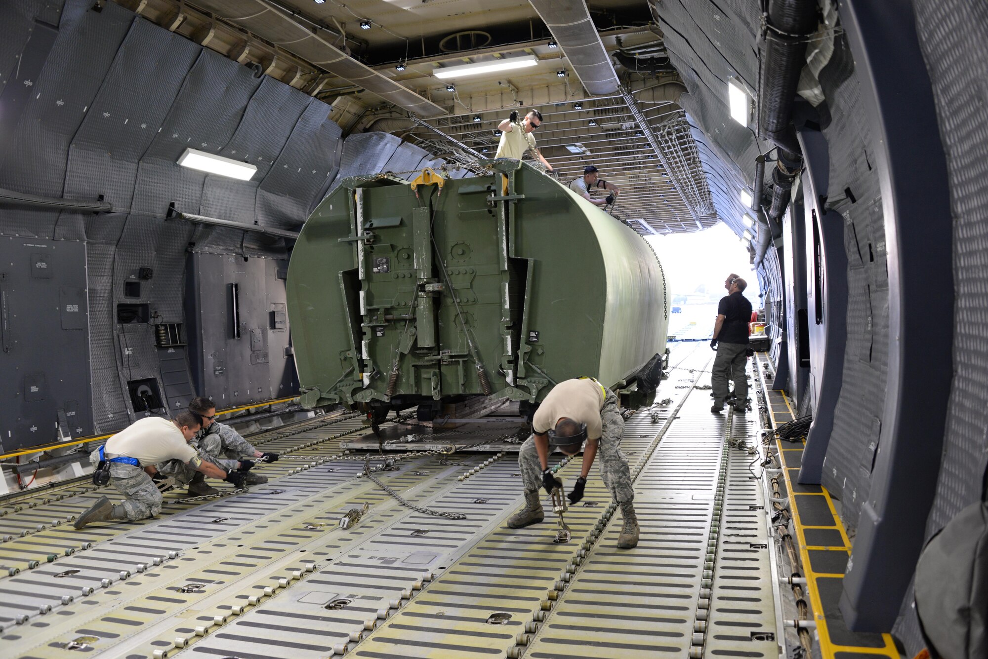 Airmen from the 60th Aerial Port Squadron load a C-5M Super Galaxy with essential cargo and U.S. Army Bridge Erection boats and bridges, May 12, 2016, at Travis Air Force Base, Calif. The bridges and cargo were flown to Iraq by the 22nd Airlift Squadron and directly contributed to the counter-Islamic State of Iraq and the Levant campaign during Operation Inherent Resolve in Mosul, Iraq. (U.S. Air Force photos by Senior Airman Amber Carter)
