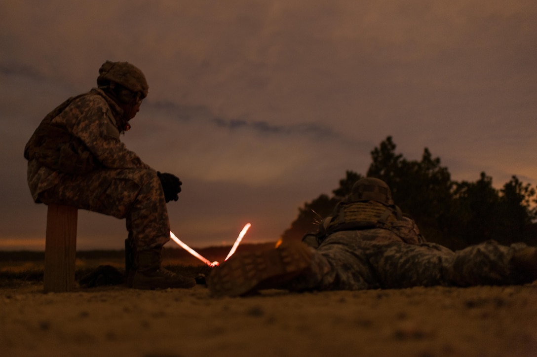 Tracer rounds fly down range as a competitor engages targets during a night fire event on the second day of the U.S. Army Forces Command Weapons Marksmanship Competition Nov. 8, 2016, at Fort Bragg, N.C. The four-day FORSCOM competition features marksmen from the U.S. Army, U.S. Army Reserve, and the National Guard in events for the M9 pistol, the M4A1 rifle and the M249 SAW, or Squad Automatic Weapon, to recognize Soldiers who are beyond expert marksmen. The multi-tiered events challenge the competitors' ability to accurately and quickly engage targets in a variety of conditions and environments. (U.S. Army photo by Timothy L. Hale/Released)