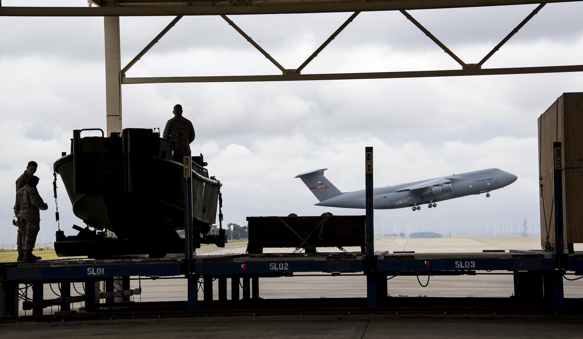 Aerial porters assigned to the 60th Aerial Port Squadron secure a U.S. Army Bridge Erection Boat (BEB) to the unit's loading dock May 6, 2016, at Travis Air Force Base, Calif. The 60th APS successfully uploaded multiple BEBs and bridges onto a C-5M Super Galaxy in support of the counter-Islamic State of Iraq and the Levant campaign in Iraq as part of Operation Inherent Resolve. (U.S. Air Force photo by Staff Sgt. Charles Rivezzo)