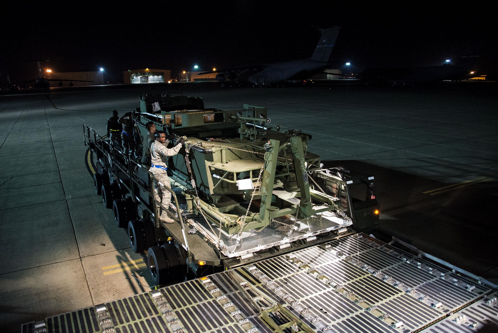 Airmen assigned to the 60th Aerial Port Squadron push a  U.S. Army Bridge Erection Boat (BEB) off a Tunner 60K loader onto a C-5M Super Galaxy May 7, 2016, at Travis Air Force Base, Calif. The 60th APS successfully uploaded multiple BEBs and bridges onto the aircraft where they were transported to Iraq in support of Operation Inherent Resolve. (U.S. Air Force by Staff Sgt. Charles Rivezzo)