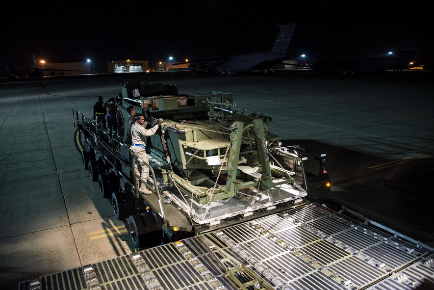 Airmen assigned to the 60th Aerial Port Squadron push a  U.S. Army Bridge Erection Boat (BEB) off a Tunner 60K loader onto a C-5M Super Galaxy May 7, 2016, at Travis Air Force Base, Calif. The 60th APS successfully uploaded multiple BEBs and bridges onto the aircraft where they were transported to Iraq in support of Operation Inherent Resolve. (U.S. Air Force by Staff Sgt. Charles Rivezzo)