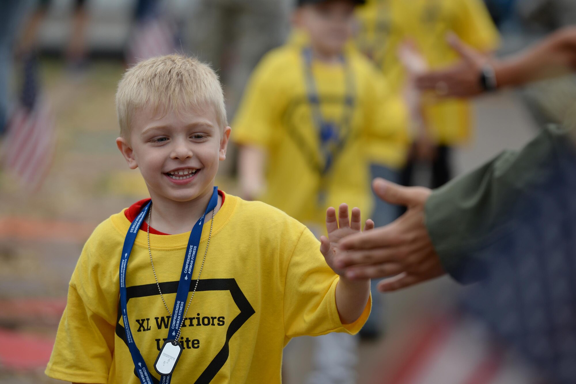 A junior deployer celebrates as he returns from his mock deployment, on Laughlin Air Force Base, Texas, Nov. 5, 2016. A junior deployment was held for base and local children to experience what a deployment could be like for military members. (U.S. Air Force photo/Airman 1st Class Benjamin N. Valmoja)