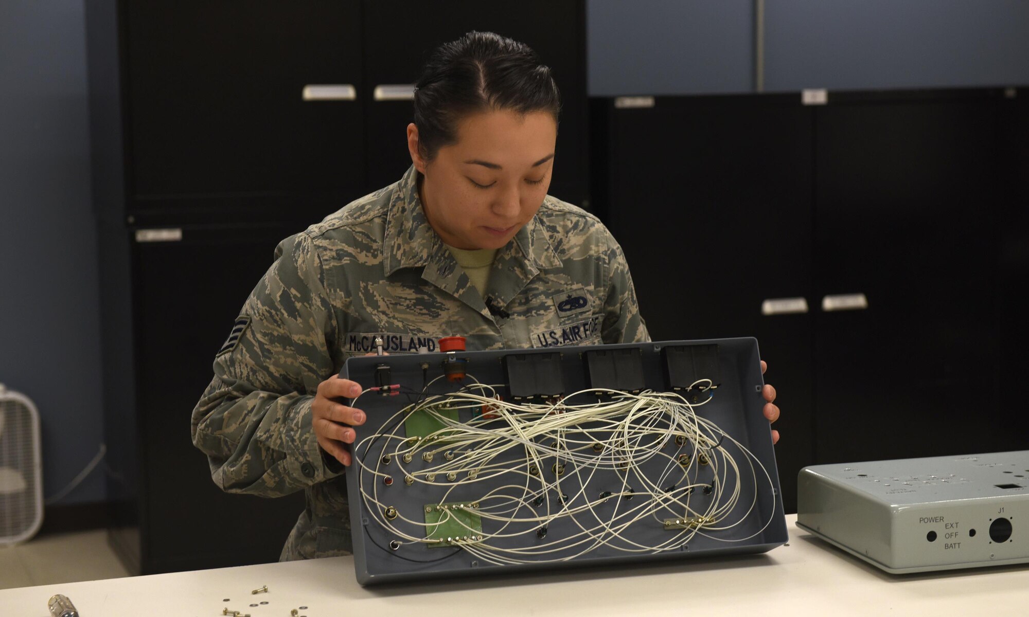 U.S. Air Force Staff Sgt. Elizabeth McCausland, 53rd Test Support Squadron Special Devices Flight electrical and environmental systems specialist, displays the wiring on a device used to perform preflight tests on the QF-16 at Tyndall Air Force Base, Fla., Nov. 2, 2016. The avionic section of the special devices flight uses specialized design and fabrication machines that are able to 3-D print and create customized circuit boards. (U.S. Air Force photo by Airman 1st Class Cody R. Miller/Released) 