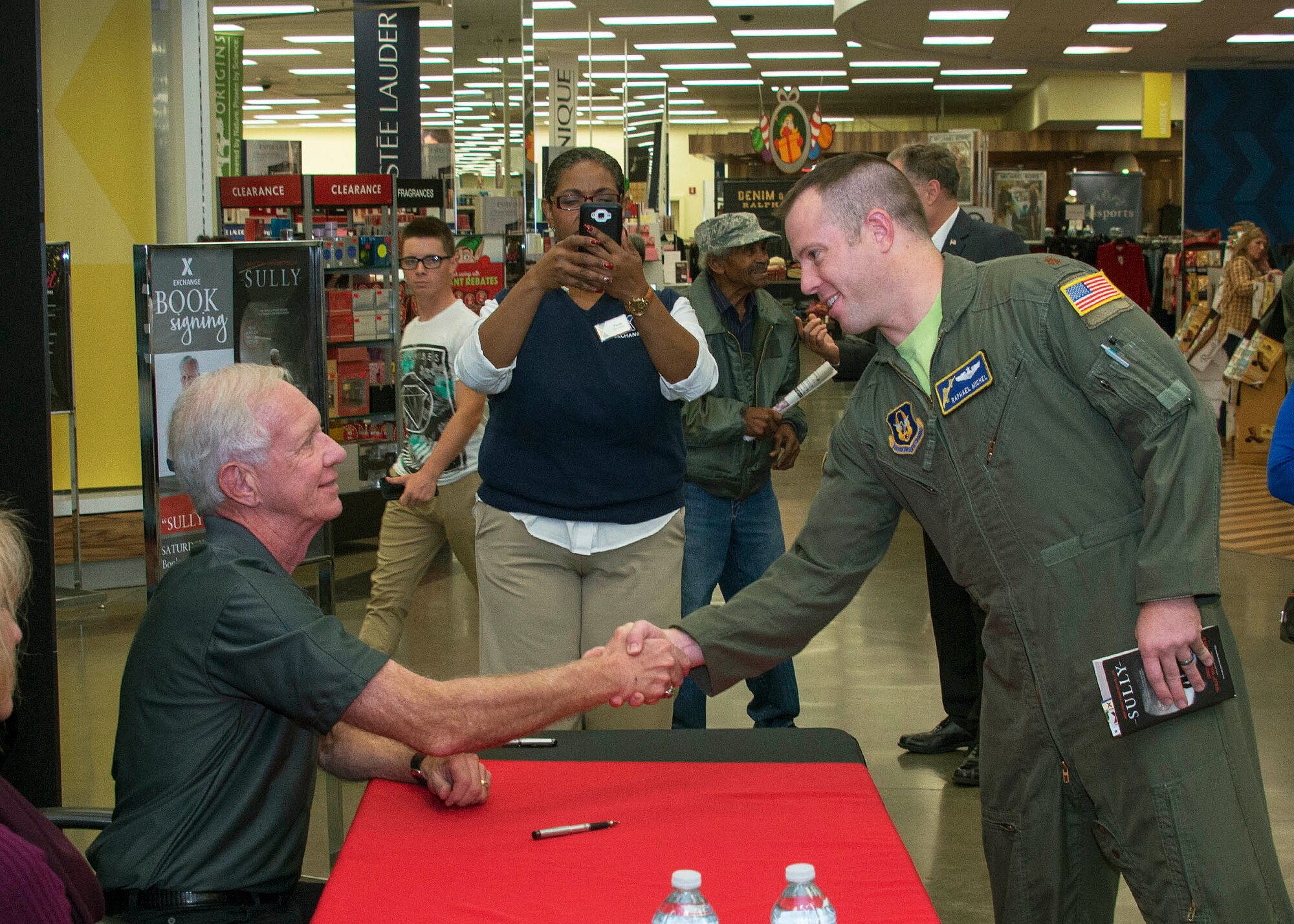 Maj. Raphael Michel, 349th Operations Support Squadron, greets Capt. Chesley "Sully" Sullenberger, who met with more than 500 Airmen at the Travis Base Exchange at Travis Air Force Base, Calif., Nov. 5, 2016. Sullenberger became a national hero in 2009 when he landed a damaged Airbus A320 passenger jet in the Hudson River. During his visit, Sullenberger met with more than 500 Airmen and their families. (US Air Force Photo by T.C. Perkins Jr.)