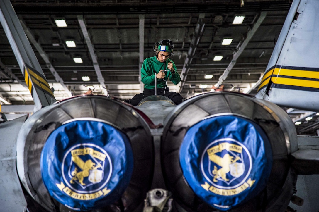 Navy Petty Officer 3rd Class Jeric Eslabra opens panels on an F/A-18F Super Hornet for a 336-day inspection in the hangar bay of the USS Dwight D. Eisenhower in the Persian Gulf, Nov. 7, 2016. Elsabra is an aviation structural mechanic. The aircraft carrier is supporting Operation Inherent Resolve, maritime security operations and theater security cooperation efforts in the U.S. 5th Fleet area of operations. Navy photo by Petty Officer 3rd Class Nathan T. Beard