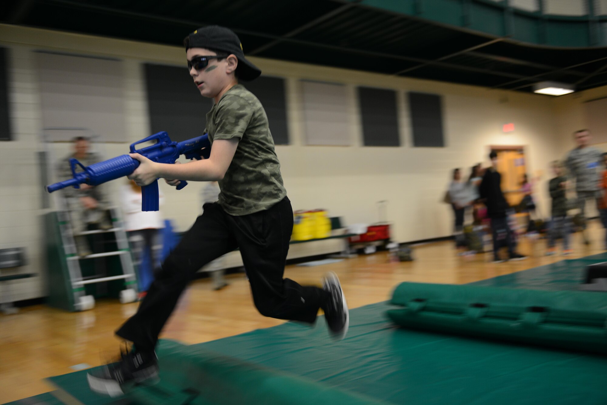 A junior deployer runs through the obstacle course section of “Operation XL,” on Laughlin Air Force Base, Texas, Nov. 5, 2016. “Operation XL” was a mock deployment held by the Airman and Family Readiness Center for base and local children to experience what a deployment could be like for military members. (U.S. Air Force photo/Airman 1st Class Benjamin N. Valmoja)