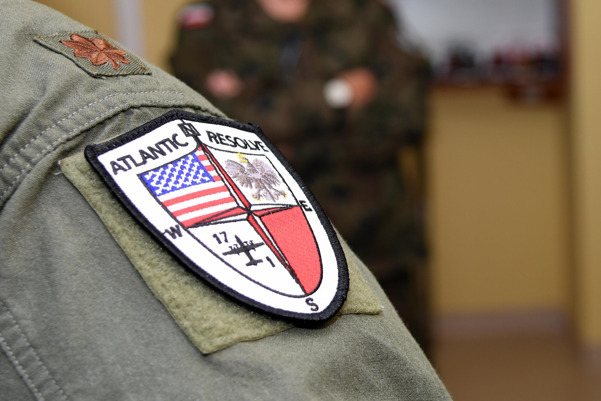 An Airman from the 94th Airlift Wing, Dobbins Air Reserve Base, Ga., wears a unit-designed uniform patch representing Operation Atlantic Resolve, while working at Powidz Air Base, Poland, Oct. 19, 2016. The 94th AW and the 86th Airlift Wing, Ramstein Air Base, Germany, trained with the Polish air force during Aviation Detachment 17-1 in support of the operation, Oct. 3-28. (U.S. Air Force photo by Staff Sgt. Alan Abernethy) 