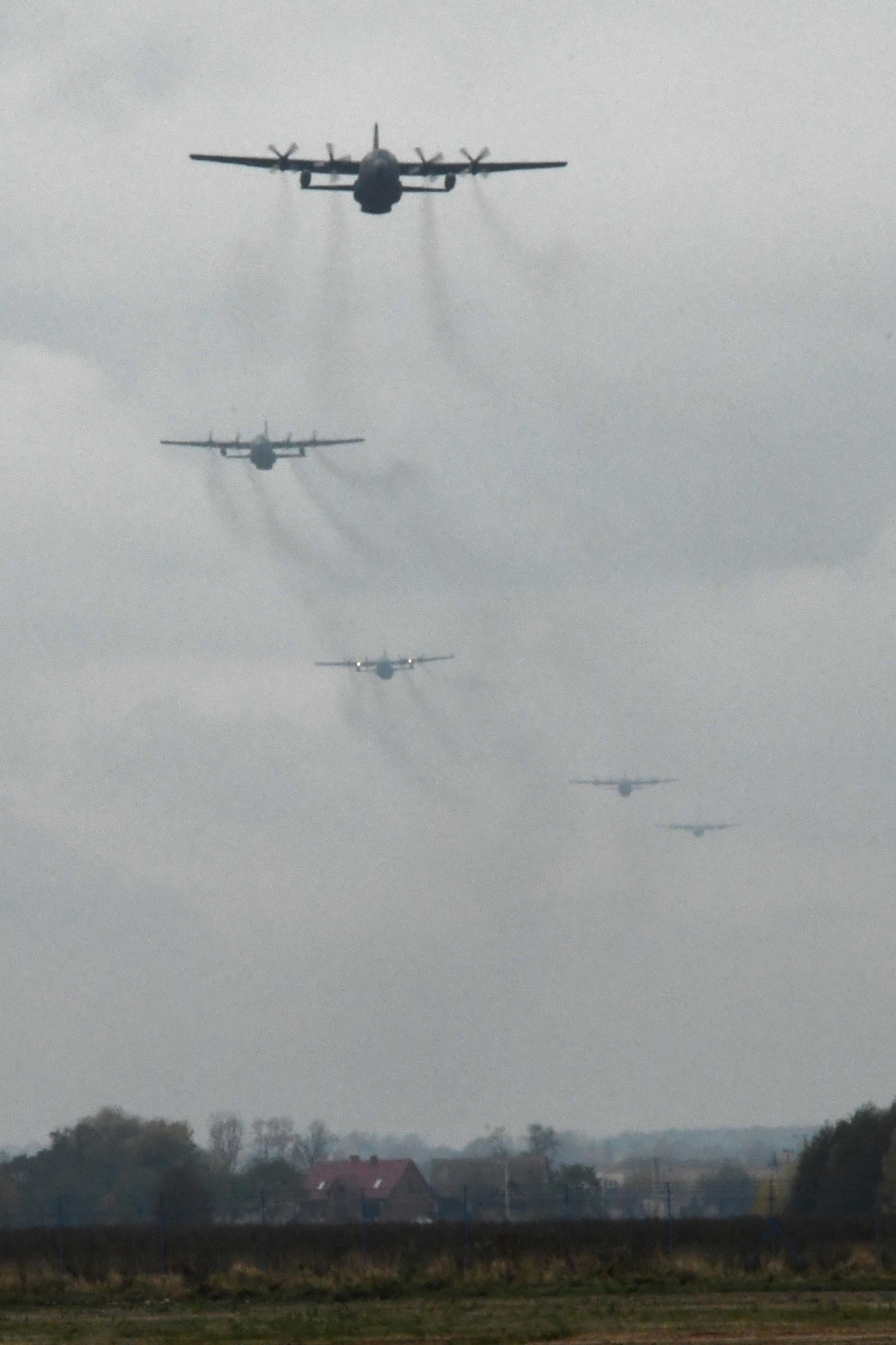 A five-ship formation of C-130 Hercules aircraft approach Powidz Air Base Poland, during Aviation Detachment 17-1 in support of Operation Atlantic Resolve, Oct. 26, 2016. The formation included one C-130E Hercules from the 33rd Air Transport Base, Powidz AB; two C-130H Hercules aircraft from the 94th Airlift Wing, Dobbins Air Reserve Base, Ga.; and two C-130J Super Hercules aircraft from the 86th Airlift Wing, Ramstein Air Base, Germany. (U.S. Air Force photo by Staff Sgt. Alan Abernethy)