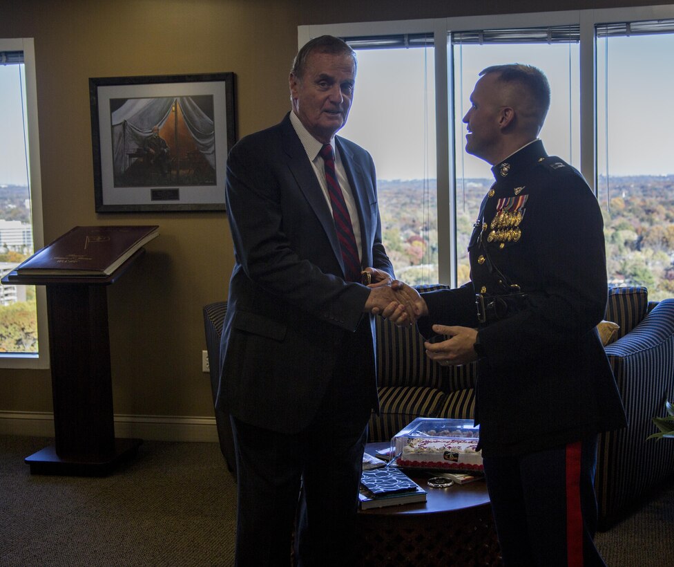 Thirty-second Commandant of the Marine Corps, retired Gen. James L. Jones, and former National Security Advisor to President Barack Obama, greets Capt. Benjamin J. Grodi, command legal advisor at Marine Barracks Washington, D.C., at Jones Group International, McLean, Va., Nov. 7, 2016. Each year, the Barracks’ command hand-delivers cakes to former commandants in the D.C. area to thank them for their service and to honor the birth of the Corps. (Official Marine Corps photo by Lance Cpl. Robert Knapp/Released)