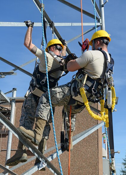 Airman 1st Class David Tran, 9th Communication Squadron cable and antenna maintainer, simulates a rescue of Senior Airman Wade Gay, 9th CS cable and antenna maintainer, Nov. 8, 2016, at Beale Air Force Base, California. Climbers must demonstrate the ability to perform a rescue as a requirement to be certified. (U.S. Air Force photo/Airman Tristan D. Viglianco)