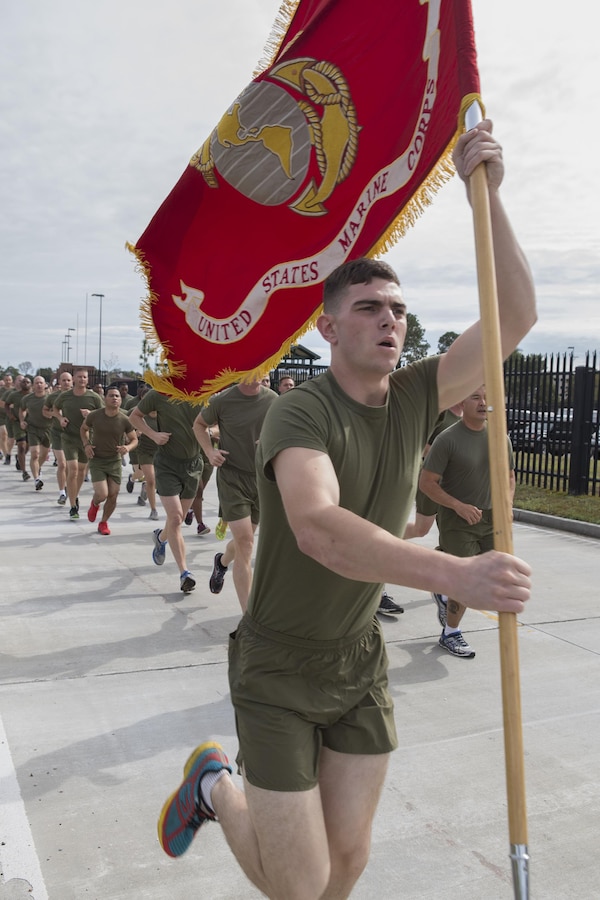 Corporal Cody J. Brannan, an admin specialist with Marine Forces Reserve, carries the Marine Corps flag during a 3-mile motivational formation run here, Nov. 9, 2016. Each year, the Marines celebrate the Corps’ birthday with a cake-cutting ceremony followed by a run. Since Nov. 10, 1775, the United States Marine Corps has earned the reputation as the world's most effective expeditionary fighting force – engaging in combat on battlefields across the globe. (U.S. Marine Corps photo by Sgt. Sara Graham)