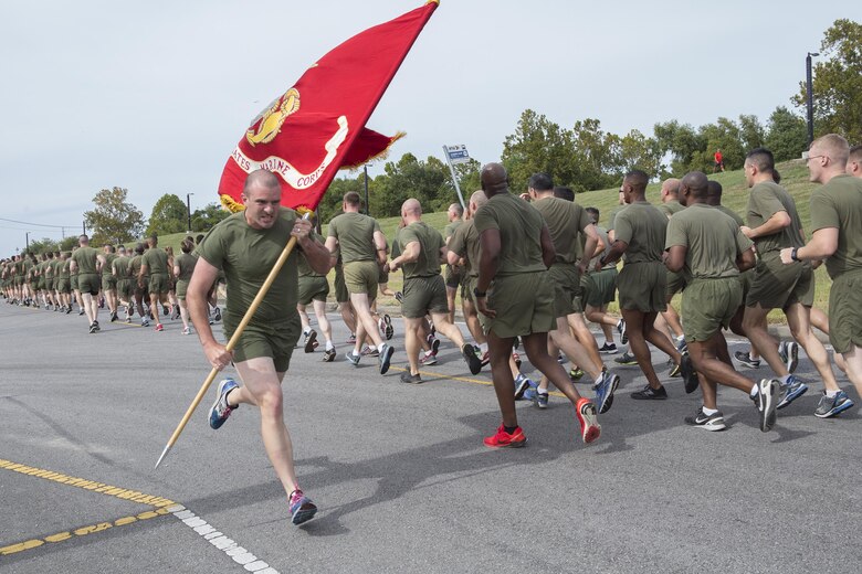 Lance Cpl. Benjamin T. Kulp, a fiscal clerk with Marine Forces Reserve, carries the Marine Corps Flag through the streets here during a 3-mile motivational formation run, Nov. 9, 2016. Each year, the Marines celebrate the Corps’ birthday with a cake-cutting ceremony followed by a run. Since Nov. 10, 1775, the United States Marine Corps has earned the reputation as the world's most effective expeditionary fighting force - engaging in combat on battlefields across the globe. (U.S. Marine Corps photo by Sgt. Sara Graham)