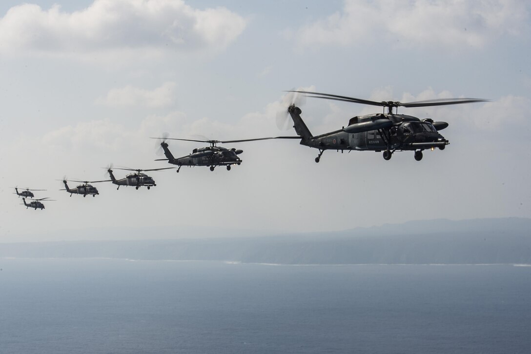 HH-60 Pave Hawks from 33rd Rescue Squadron, 943rd Rescue Group and Japan Air Self-Defense Force, fly in formation behind an MC-130J from the 17th Special Operations Squadron during exercise Keen Sword 17, Nov. 7, 2016, near Okinawa, Japan. The U.S.-Japan mutual security treaty is a symbol of the U.S. commitment to Japan and the region and allows the U.S. to provide forward-based forces that can rapidly react to counter aggression against Japan and other allies and partners. . (U.S. Air Force photo by Senior Airman Stephen G. Eigel/released)