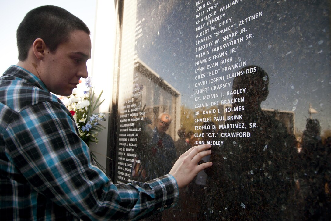 A family member reflects after viewing a loved one’s name inscribed on the City of Henderson, Nev. Veterans Memorial Wall during a Veterans Day celebration, Nov. 5.  Each year Henderson city leaders are joined by those who have served our country, those who continue the fight, and families and friends of veterans to celebrate the lives and actions of our military personnel in protecting this great nation. (U.S. Air Force photo by Lawrence Crespo)