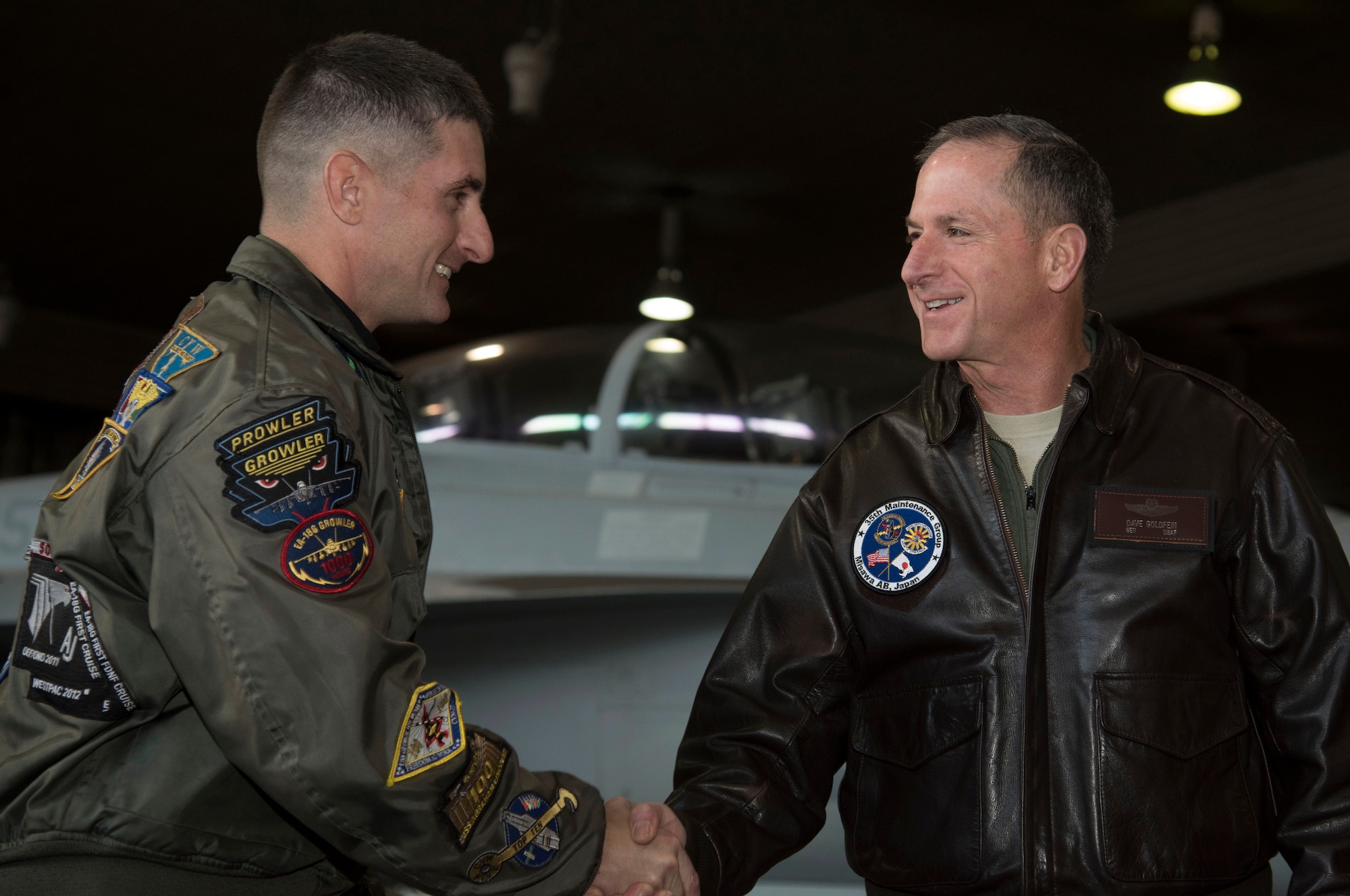 U.S. Navy Commander Michael Lisa, left, the VAQ-135 executive officer, shakes hands with Air Force Chief of Staff, Gen. David L. Goldfein, right, during his immersion tour at Misawa Air Base, Japan, Nov. 9, 2016. During his immersion tour, Goldfein took time to address many opportunities Airmen and their civilian counterparts have at Misawa, while discussing his focus areas as CSAF. (U.S. Air Force photo by Airman 1st Class Sadie Colbert)