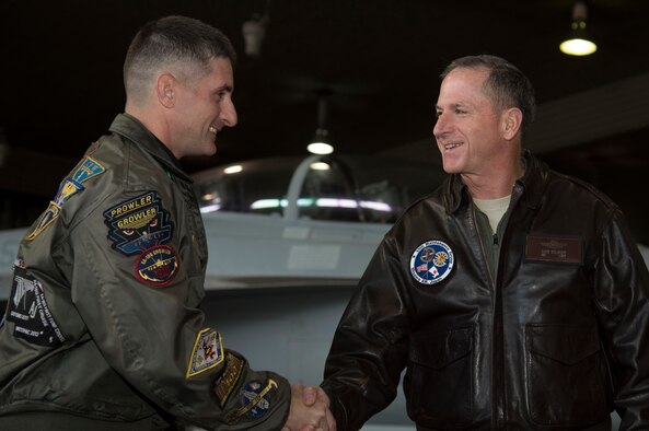 U.S. Navy Commander Michael Lisa, left, the VAQ-135 executive officer, shakes hands with Air Force Chief of Staff, Gen. David L. Goldfein, right, during his immersion tour at Misawa Air Base, Japan, Nov. 9, 2016. During his immersion tour, Goldfein took time to address many opportunities Airmen and their civilian counterparts have at Misawa, while discussing his focus areas. (U.S. Air Force photo by Airman 1st Class Sadie Colbert)