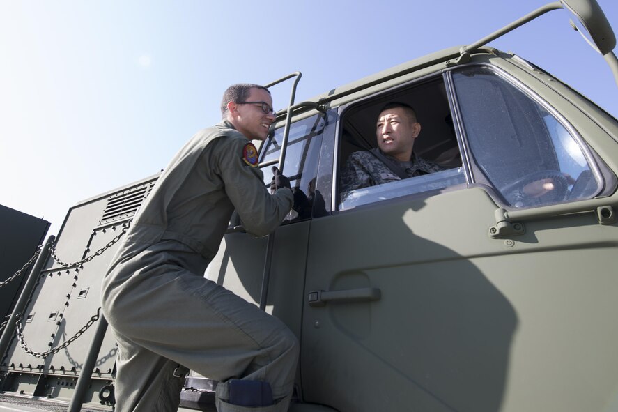 (Left to right) U.S. Air Force Senior Airman Nelson Jones, 535th Airlift Squadron C-17 loadmaster, and Japan Air Self-Defense Force Master Sgt. Shiro Suzuki, 10th Fire Unit Chitose Air Base, check a JASDF Electric Power Plant vehicle before loading onto a C-17 Globemaster III at Yokota Air Base, Japan, Nov. 6, 2016, during the exercise Keen Sword 2017. Units from the U.S. military conduct training with their Japan Self-Defense Forces counterparts at military installations throughout Japan, the Mariana Islands and in the surrounding waters. (U.S. Air Force photo by Yasuo Osakabe/Released)