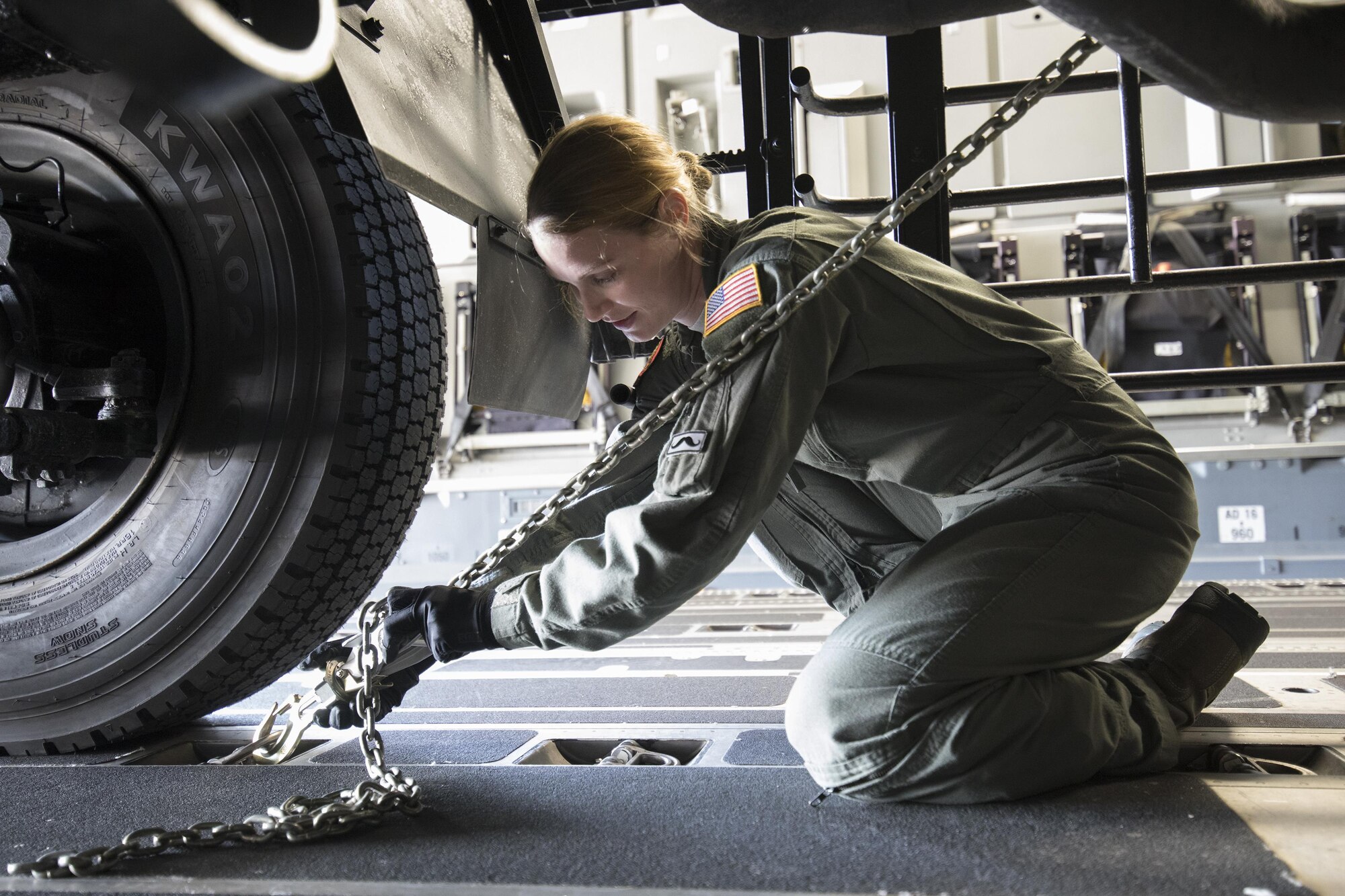 U.S. Air Force Airman 1st Class Lauren Sheppard, 535th Airlift Squadron C-17 loadmaster, secures a tie-down chain on a Japan Air Self-Defense Force Electric Power Plant vehicle Nov. 6, 2016 at Yokota Air Base, Japan, during the exercise Keen Sword 2017. This is the first time the vehicle loading onto a C-17. Units from the U.S. military conduct training with Japan Self-Defense Forces counterparts at military installations throughout Japan, the Mariana Islands and in the surrounding waters. All participating units train in a comprehensive scenario that is designed to practice the critical capabilities and interoperability required to support the defense of Japan, and to respond to a potential crisis or contingency in the Indo-Asia-Pacific region. (U.S. Air Force photo by Yasuo Osakabe/Released)