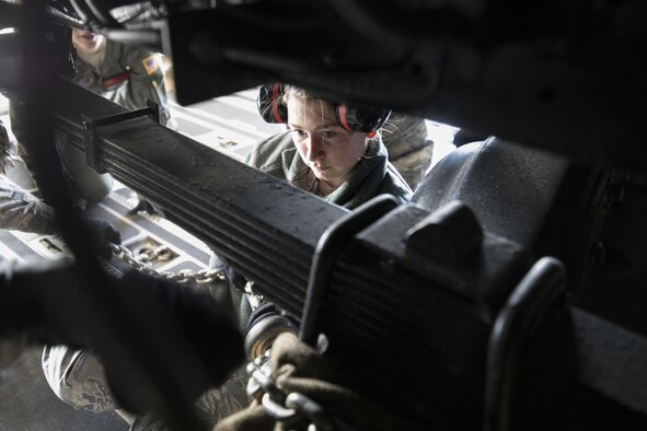 U.S. Air Force Airman 1st Class Ashley Dennis, 730th Air Mobility Squadron air freight technician, secures a tie-down chain on a Japan Air Self-Defense Force (JASDF) Electric Power Plant vehicle Nov. 6, 2016 at Yokota Air Base, Japan, during exercise Keen Sword 2017. Units from the U.S. military conduct training with JASDF counterparts at military installations throughout Japan, the Mariana Islands and in the surrounding waters. All participating units train in a comprehensive scenario that is designed to practice the critical capabilities and interoperability required to support the defense of Japan, and to respond to a potential crisis or contingency in the Indo- Asia-Pacific region. (U.S. Air Force photo by Yasuo Osakabe/Released)