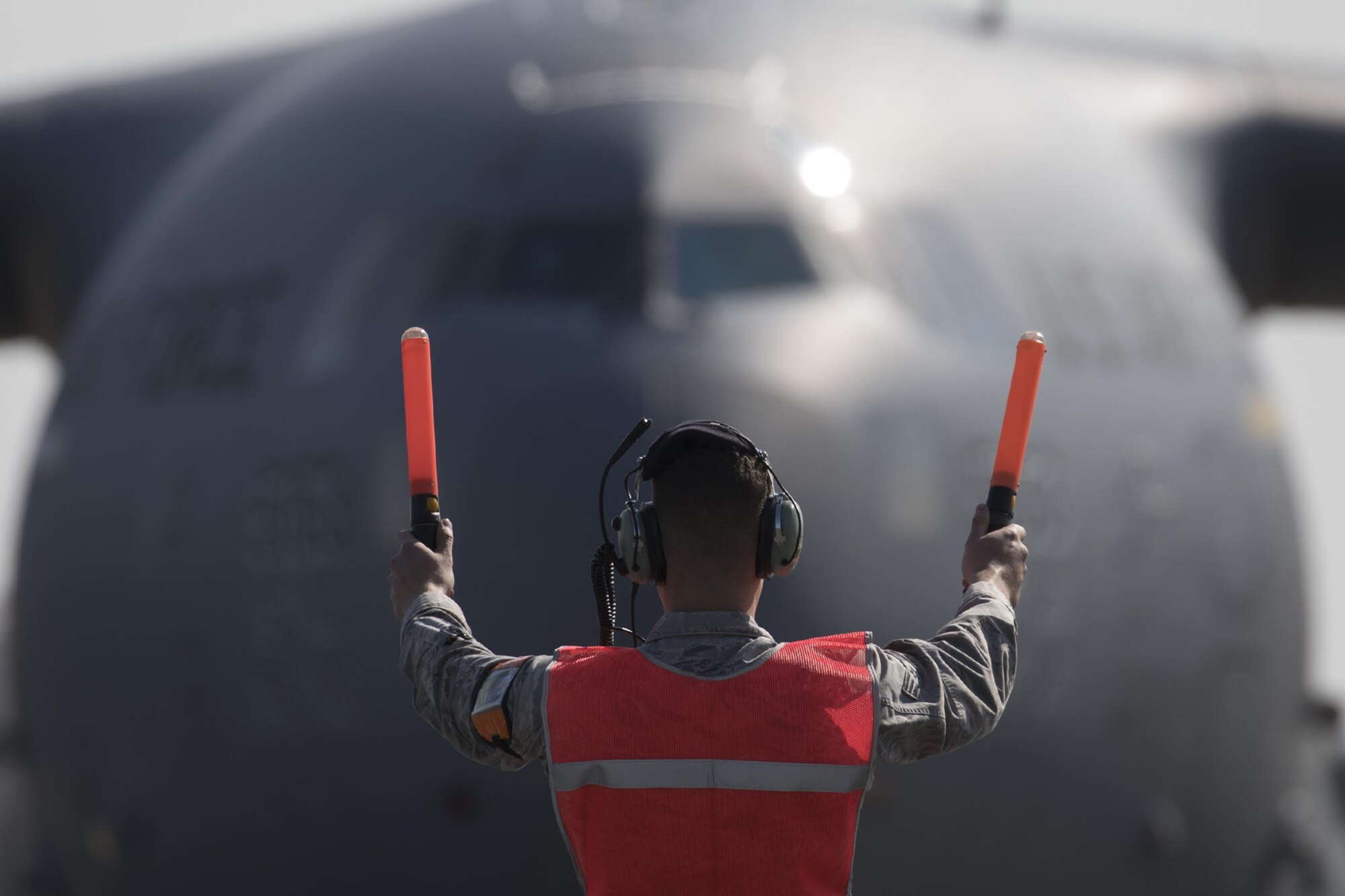 A U.S. Air Force crew chief marshals a C-17 Globemaster III at Yokota Air Base, Japan, Nov. 6, 2016, during the exercise Keen Sword 2017. This is the first time the vehicle loading onto a C-17. Units from the U.S. military conduct training with Japan Self-Defense Forces counterparts at military installations throughout Japan, the Mariana Islands and in the surrounding waters. All participating units train in a comprehensive scenario that is designed to practice the critical capabilities and interoperability required to support the defense of Japan, and to respond to a potential crisis or contingency in the Indo-Asia-Pacific region. (U.S. Air Force photo by Yasuo Osakabe/Released) 
