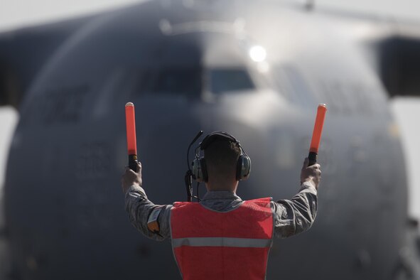 A U.S. Air Force crew chief marshals a C-17 Globemaster III at Yokota Air Base, Japan, Nov. 6, 2016, during exercise Keen Sword 2017. Units from the U.S. military conduct training with Japan Self-Defense Forces counterparts at military installations throughout Japan, the Mariana Islands and in the surrounding waters. All participating units train in a comprehensive scenario that is designed to practice the critical capabilities and interoperability required to support the defense of Japan, and to respond to a potential crisis or contingency in the Indo-Asia-Pacific region. (U.S. Air Force photo by Yasuo Osakabe/Released) 