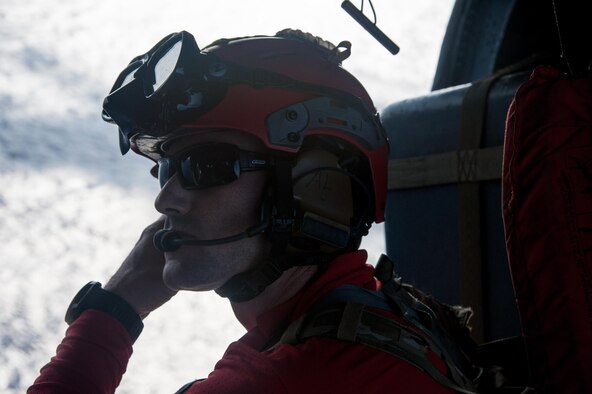 U.S. Air Force Staff Sgt. Adam Lopez, assigned to the 31st Rescue Squadron (RQS) as a pararescueman, performs a communications check aboard a HH-60G Pave Hawk helicopter assigned to the 33rd RQS during exercise Keen Sword 17, Nov. 4, 2016, near Okinawa, Japan. During the training, members of the 33rd RQS practiced recovery operations for a simulated downed pilot in a hostile environment. (U.S. Air Force photo by Senior Airman John Linzmeier)
