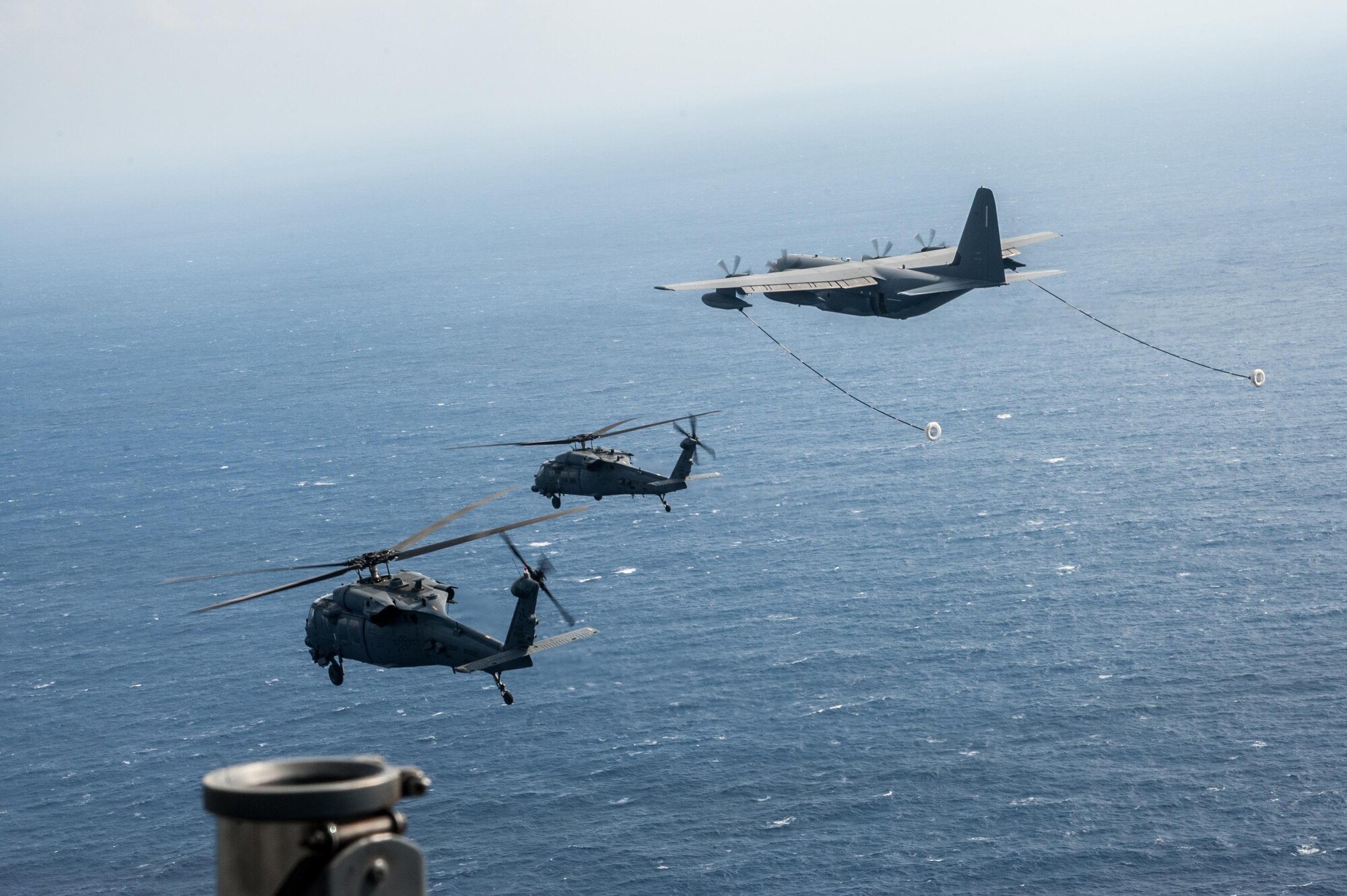 U.S. Air Force HH-60G Pave Hawks from the 33rd Rescue Squadron fly in formation with a MC-130J Commando II from the 17th Special Operations Squadron for exercise Keen Sword Nov. 4, 2016, off the coast of Okinawa, Japan. Air Force rescue squadrons frequently train on a multitude of scenarios in order to stay prepared for potential real-world contingencies and operations. (U.S. Air Force photo by Senior Airman John Linzmeier)