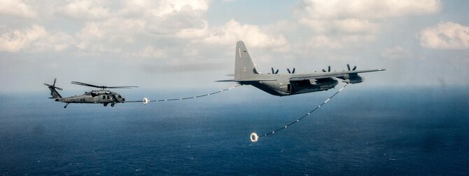 A U.S. Air Force HH-60G Pave Hawk helicopter assigned to the 33rd Rescue Squadron (RQS) performs in-flight refueling with a MC-130J Commando II assigned to the 17th Special Operations Squadron during a training exercise Nov. 4, 2016, near Okinawa, Japan. The 33rd RQS performs military personnel recovery, civil search and rescue, medical evacuation, disaster response, and humanitarian assistance. (U.S. Air Force photo by Senior Airman John Linzmeier)