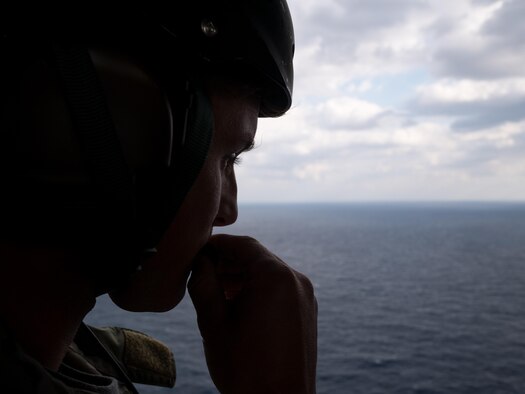 U.S. Air Force Staff Sgt. Caleb Williams,  assigned to the 18th Operations Support Squadron as a Survival, Evasion, Resistance, and Escape specialist, performs a communications check aboard a HH-60G Pave Hawk helicopter assigned to the 33rd Rescue Squadron during exercise Keen Sword Nov. 4, 2016, near Okinawa, Japan. During the exercise, combat rescue teams train to increase the interoperability required to support the defense of Japan, respond to a potential crisis and offer humanitarian assistance.  (U.S. Air Force photo by Senior Airman John Linzmeier)