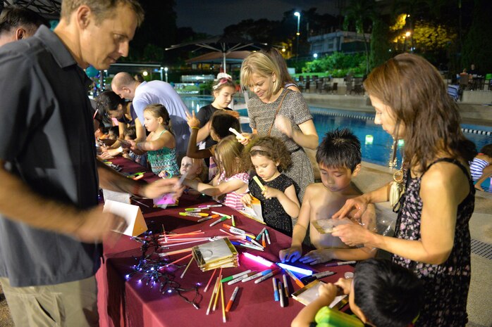 SINGAPORE (Nov. 7, 2016) – Aria Terry, sets a glow lantern afloat at Navy Region Singapore’s Terror Club during an event to raise awareness about domestic violence and sexual assault, Nov. 4, 2016. The lanterns symbolize giving hope and empowerment to those victims of sexual assault and domestic violence around the world. Military service members and their families along with DoD civilians assigned to Navy Region Singapore walked along the streets of Sembawang, Singapore to raise awareness and support for victims of sexual assault and domestic violence. The event entitled, Take Back the Night, included more than 30 participants who gathered to peacefully march along the streets of Singapore and take back the fear that is surrounded by the belief that violence is perpetrated by strangers in the night. (Official U.S. Navy photo by Marc Ayalin)