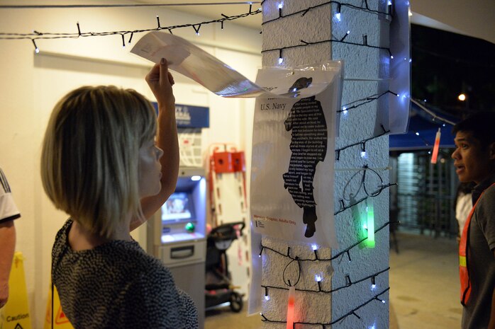 SINGAPORE (Nov. 7, 2016) – Aria Terry, sets a glow lantern afloat at Navy Region Singapore’s Terror Club during an event to raise awareness about domestic violence and sexual assault, Nov. 4, 2016. The lanterns symbolize giving hope and empowerment to those victims of sexual assault and domestic violence around the world. Military service members and their families along with DoD civilians assigned to Navy Region Singapore walked along the streets of Sembawang, Singapore to raise awareness and support for victims of sexual assault and domestic violence. The event entitled, Take Back the Night, included more than 30 participants who gathered to peacefully march along the streets of Singapore and take back the fear that is surrounded by the belief that violence is perpetrated by strangers in the night. (Official U.S. Navy photo by Marc Ayalin)