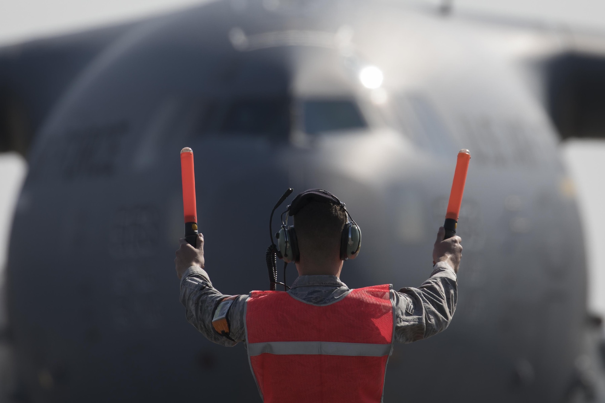 A U.S. Air Force crew chief marshals a C-17 Globemaster III at Yokota Air Base, Japan, Nov. 6, 2016, during the exercise Keen Sword 2017. This is the first time the vehicle loading onto a C-17. Units from the U.S. military conduct training with Japan Self-Defense Forces counterparts at military installations throughout Japan, the Mariana Islands and in the surrounding waters. All participating units train in a comprehensive scenario that is designed to practice the critical capabilities and interoperability required to support the defense of Japan, and to respond to a potential crisis or contingency in the Indo-Asia-Pacific region. (U.S. Air Force photo by Yasuo Osakabe/Released) 