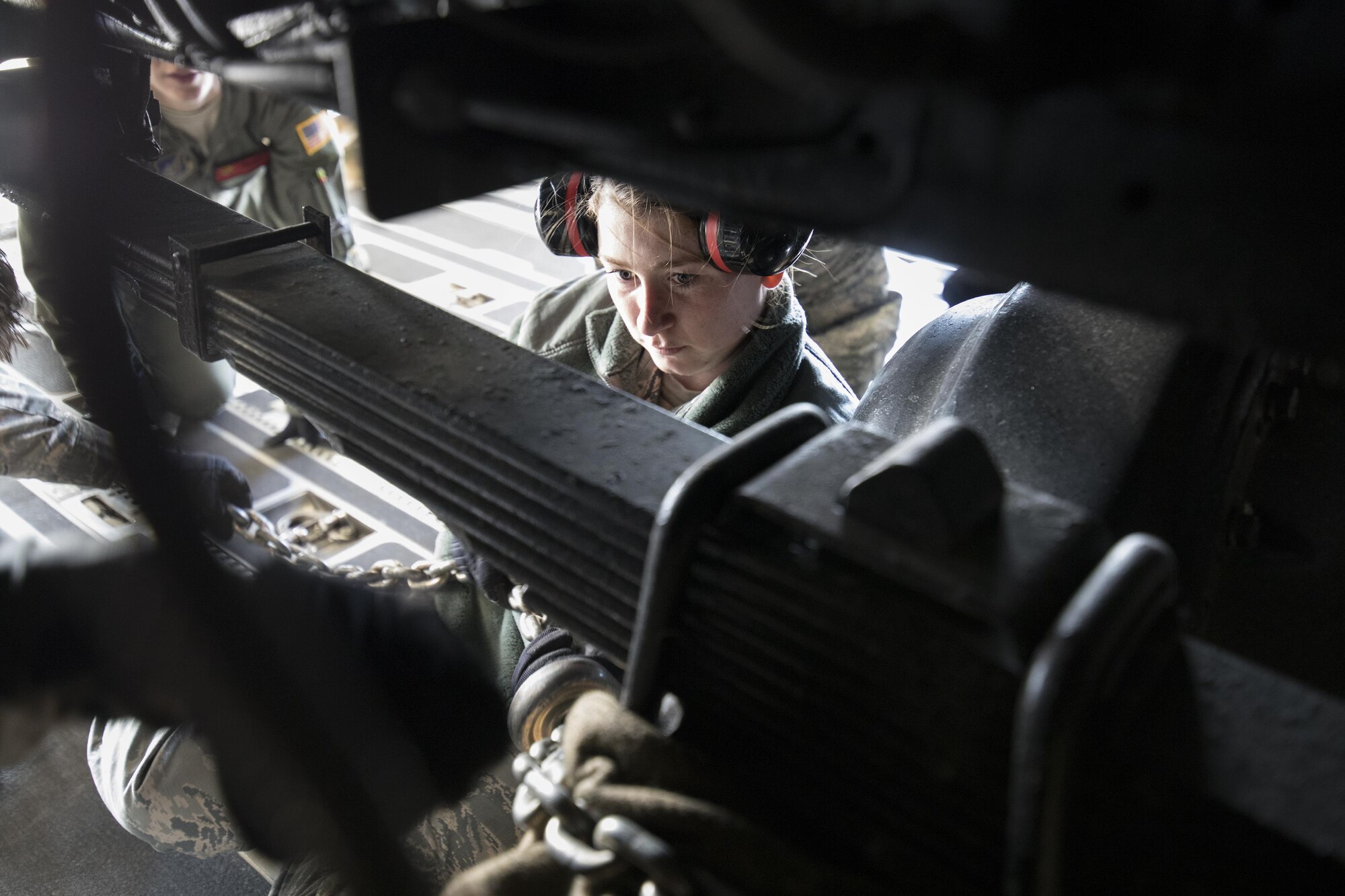U.S. Air Force Airman 1st Class Ashley Dennis, 730th Air Mobility Squadron air freight technician, secures a tie-down chain on a Japan Air Self-Defense Force Electric Power Plant vehicle Nov. 6, 2016 at Yokota Air Base, Japan, during the exercise Keen Sword 2017. This is the first time the vehicle loading onto a C-17. Units from the U.S. military conduct training with Japan Self-Defense Forces counterparts at military installations throughout Japan, the Mariana Islands and in the surrounding waters. All participating units train in a comprehensive scenario that is designed to practice the critical capabilities and interoperability required to support the defense of Japan, and to respond to a potential crisis or contingency in the Indo- Asia-Pacific region. (U.S. Air Force photo by Yasuo Osakabe/Released)