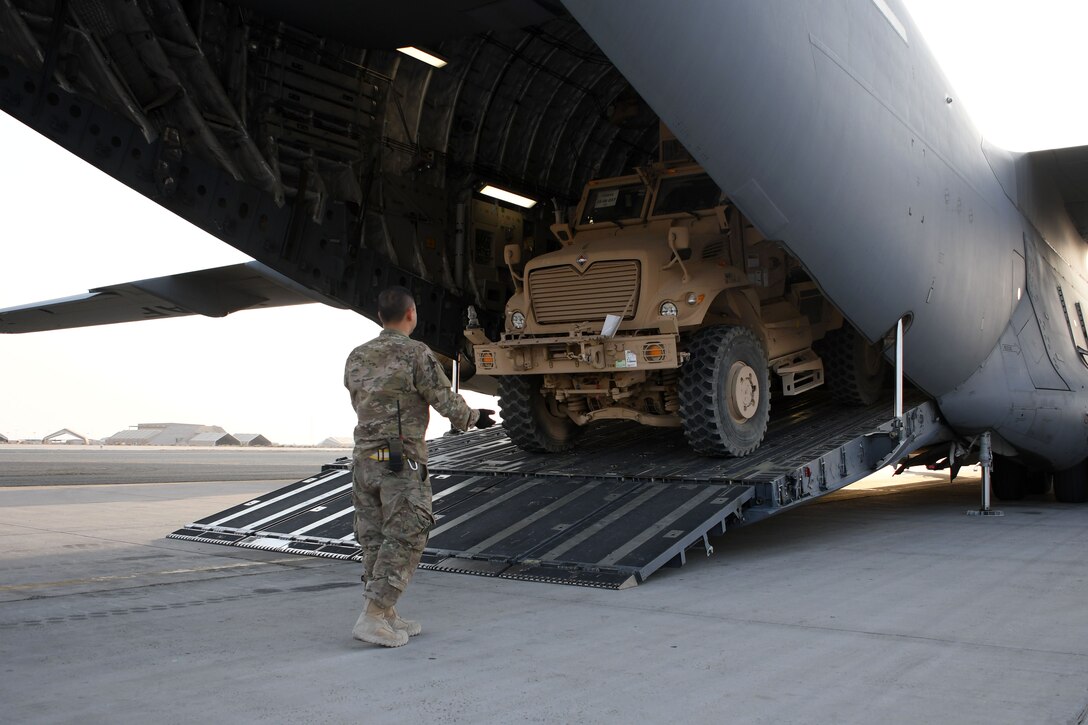 Tech Sgt. Ronald Gowen, a logistician assigned to the 387th Air Expeditionary Squadron, guides a  mine-resistant ambush-protected vehicle into the cargo area of a C-17 Globemaster III at an undisclosed location in Southwest Asia Nov. 4, 2016. Gowen leads a small Quick Response Team comprised of five specialized aerial port personnel to provide rapid response in support of various requirements around the region. (U.S. Air Force photo/Senior Airman Andrew Park)