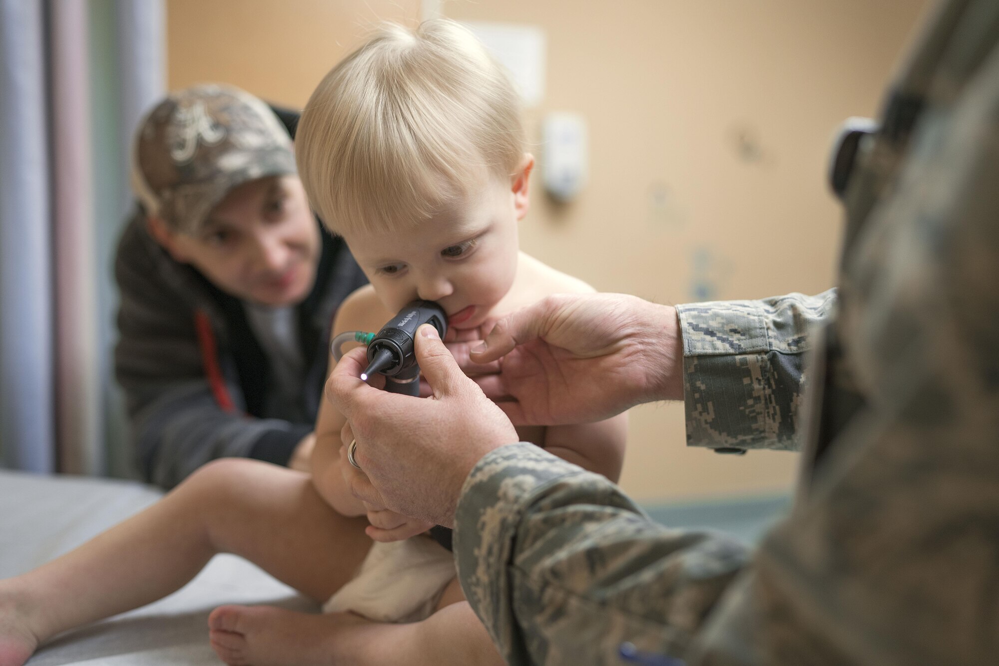 A patient examines an otoscope Nov. 2, 2016, at Yokota Air Base, Japan. The clinic's physicians and nurse practitioners conduct regular checkups, school physicals and take appointments for seasonal illnesses like influenza and allergies. (U.S. Air Force photo by Senior Airman Delano Scott/Released)