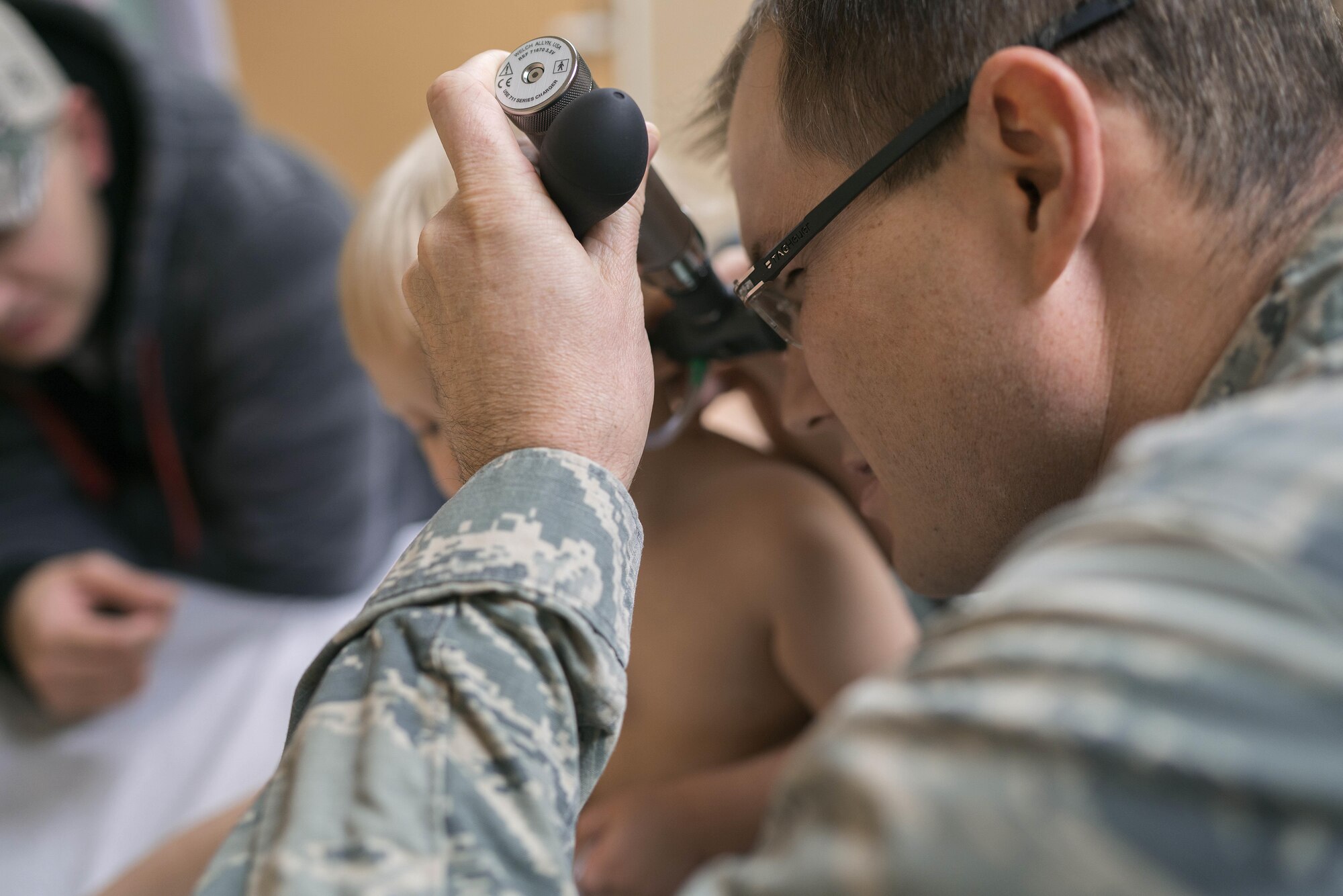 Capt. Michael Guindon, 374th Medical Group pediatrician, examines a patient’s ear Nov. 2, 2016, at Yokota Air Base, Japan. The clinic works around the clock to provide a full range of children's healthcare services to keep kids healthy. (U.S. Air Force photo by Senior Airman Delano Scott/Released)