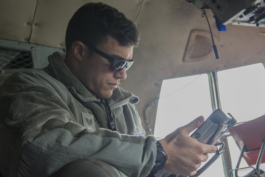 Staff Sgt. Richard Martinez, 374th Maintenance Squadron electrical and environmental journeyman, reviews technical orders while troubleshooting aboard a C-130 Hercules at Yokota Air Base, Japan, Nov. 8, 2016. The Air Force technical order system provides clear and concise instructions for safely operating and maintaining aircraft and equipment. (U.S. Air Force photo by Senior Airman David C. Danford/Released)