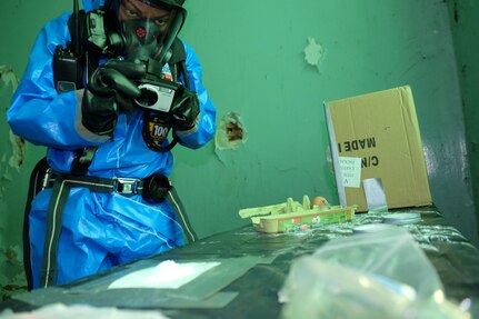 U.S. Army Staff Sgt. Camille Foggy a survey team chief with the 773rd Civil Support Team, 7th Mission Support Command takes a photo of a suspected chemical compound Nov. 2, 2016, during the NATO EADRCC Consequence Management Field Exercise "CRNA GORA 2016."