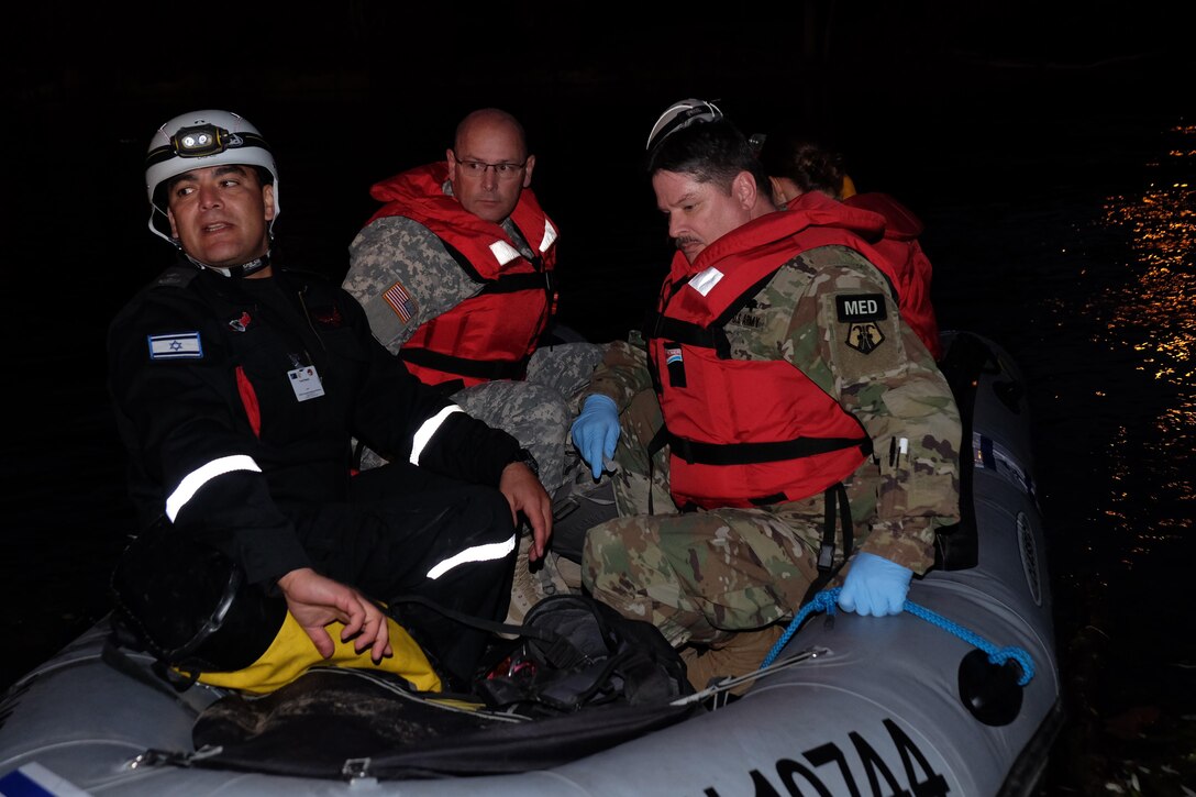 -Left to right, Yosef Dekalo, commander of the Israel fire department search and rescue team, U.S. Army Staff Sgt. Michael Rosser and U.S. Army Staff Sgt. Douglas Clemence from the 7th Mission Support Command’s Medical Support Unit-Europe float in an Israel Zodiac rescue boat Nov. 1, 2016 during the NATO EADRCC Consequence Management Field Exercise "CRNA GORA 2016."
