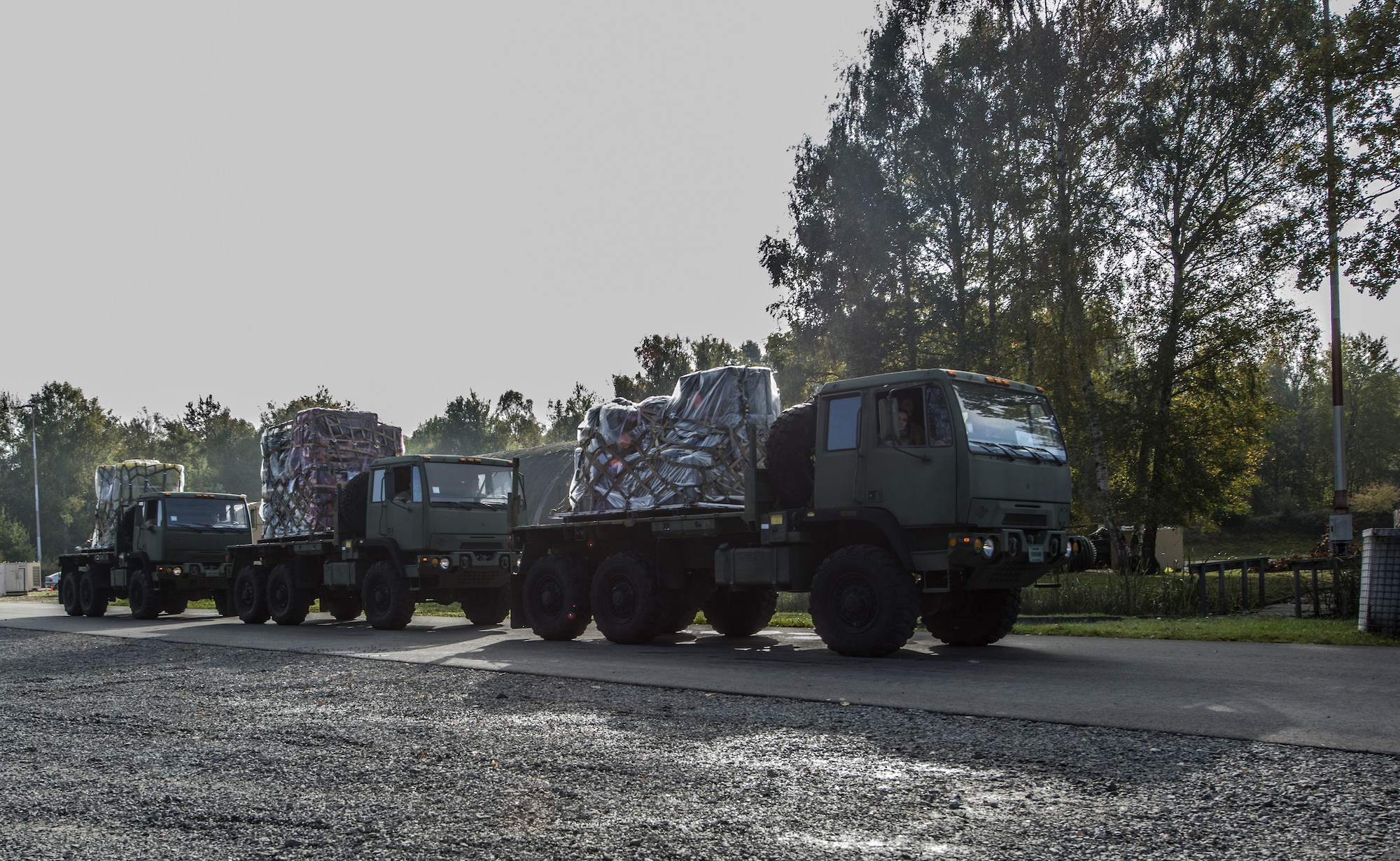 Airmen assigned to the 1st Combat Communications Squadron pull up trucks loaded with pallets during exercise Healthy Thunder at Ramstein Air Base, Germany, Oct. 26, 2016. The purpose of the two-week training exercise was to prepare the Airmen for a deployment. (U.S. Air Force photo by Senior Airman Tryphena Mayhugh)