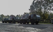 Airmen assigned to the 1st Combat Communications Squadron pull up trucks loaded with pallets during exercise Healthy Thunder at Ramstein Air Base, Germany, Oct. 26, 2016. The purpose of the two-week training exercise was to prepare the Airmen for a deployment. (U.S. Air Force photo by Senior Airman Tryphena Mayhugh)