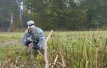 Tech. Sgt. Michael Lewis, 1st Combat Communications Squadron heating, ventilation and air conditioning technician, lays ground wires during exercise Healthy Thunder at Ramstein Air Base, Germany, Oct. 27, 2016. During the two-week exercise, the 1st CBCS Airmen set up communications in a bare-base environment and defended their site from opposing forces to prepare them for a deployment. (U.S. Air Force photo by Senior Airman Tryphena Mayhugh)