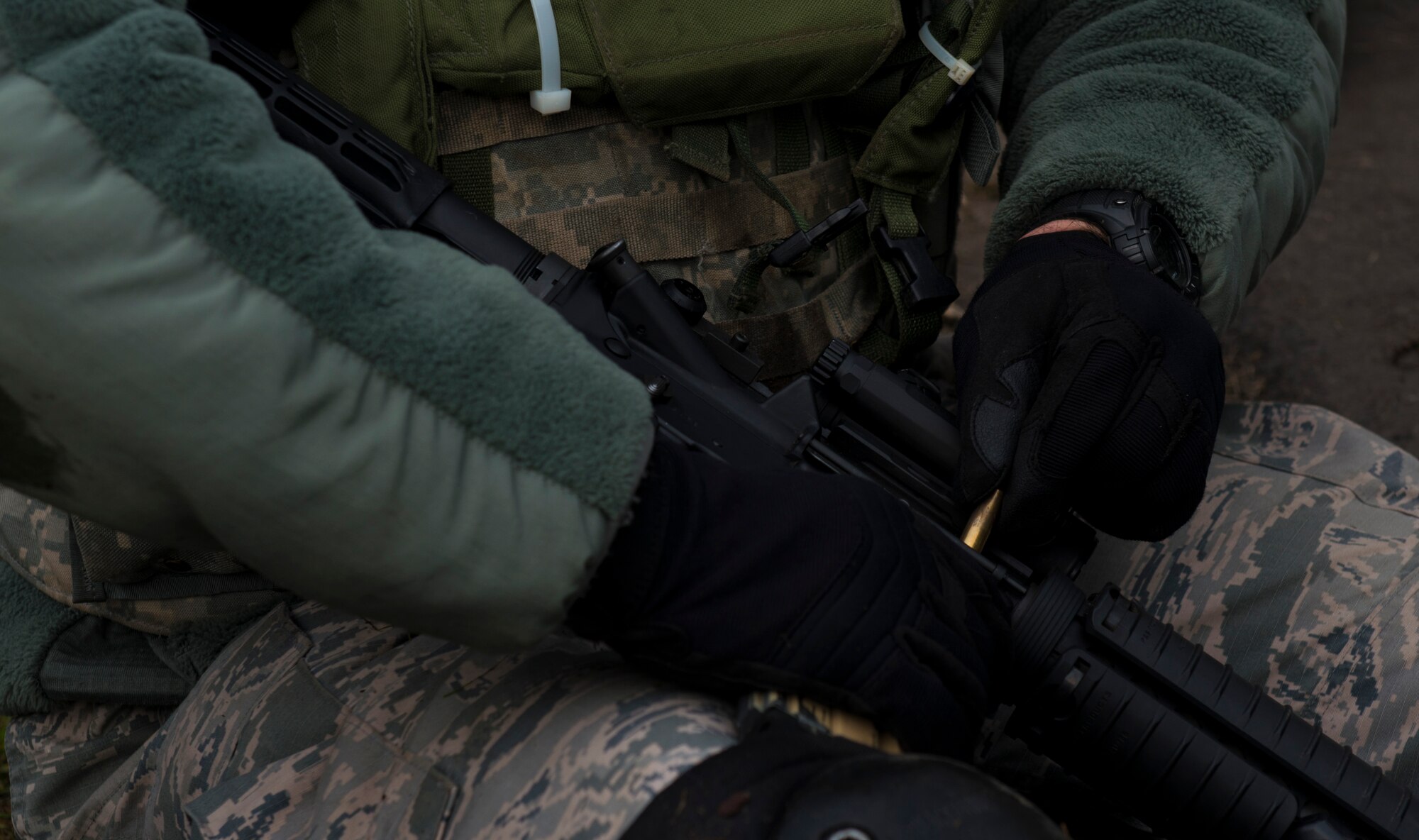 Tech. Sgt. Michael Vasseur, 1st Combat Communications Squadron cyber transport supervisor, attempts to dislodge a jammed shell casing from an M-16 rifle during exercise Healthy Thunder at Ramstein Air Base, Germany, Nov. 4, 2016. The Airmen fired blanks during the exercise to simulate a real-world combat situation. (U.S. Air Force photo by Senior Airman Tryphena Mayhugh)